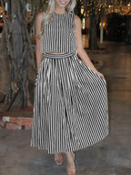 Black and white striped sleeveless midi dress with round neck and pleated skirt