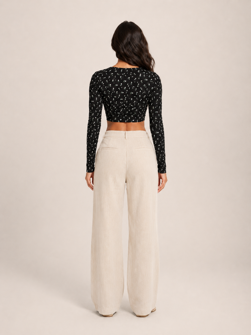 Black long-sleeve crop top with allover print, low back and center seam
