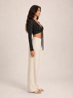 Black long-sleeve V-neck crop top with front tie and allover micro-print, side view