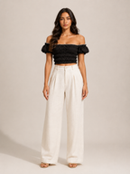 Black off-shoulder smocked top with puff sleeves, elastic bodice detail