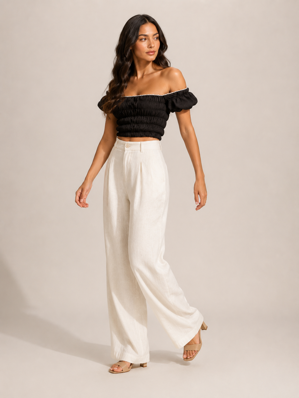 Black off-shoulder smocked top with puff sleeves, relaxed gathered bodice front view