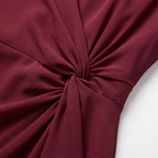 Burgundy twist-knot waist detail on a lined midi dress with draped fabric