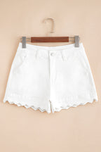 White denim shorts on hanger, high waist with button closure and scalloped hem