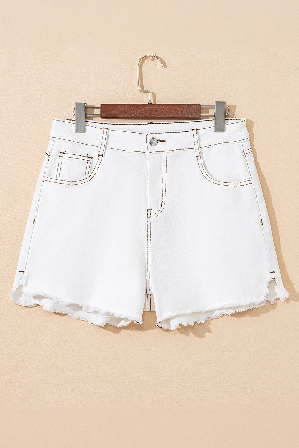 White denim shorts with high waist, frayed raw hem, fly front, belt loops, and two front pockets.