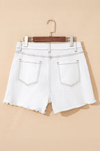 White denim shorts with high waist, frayed raw hem, back patch pockets, belt loops, and button closure.