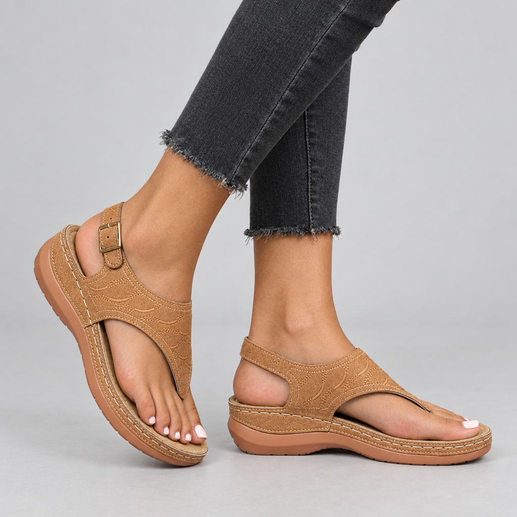 Tan toe-post thong sandals side view on model showing contoured wedge sole