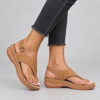 Tan toe-post thong sandals side view on model showing contoured wedge sole