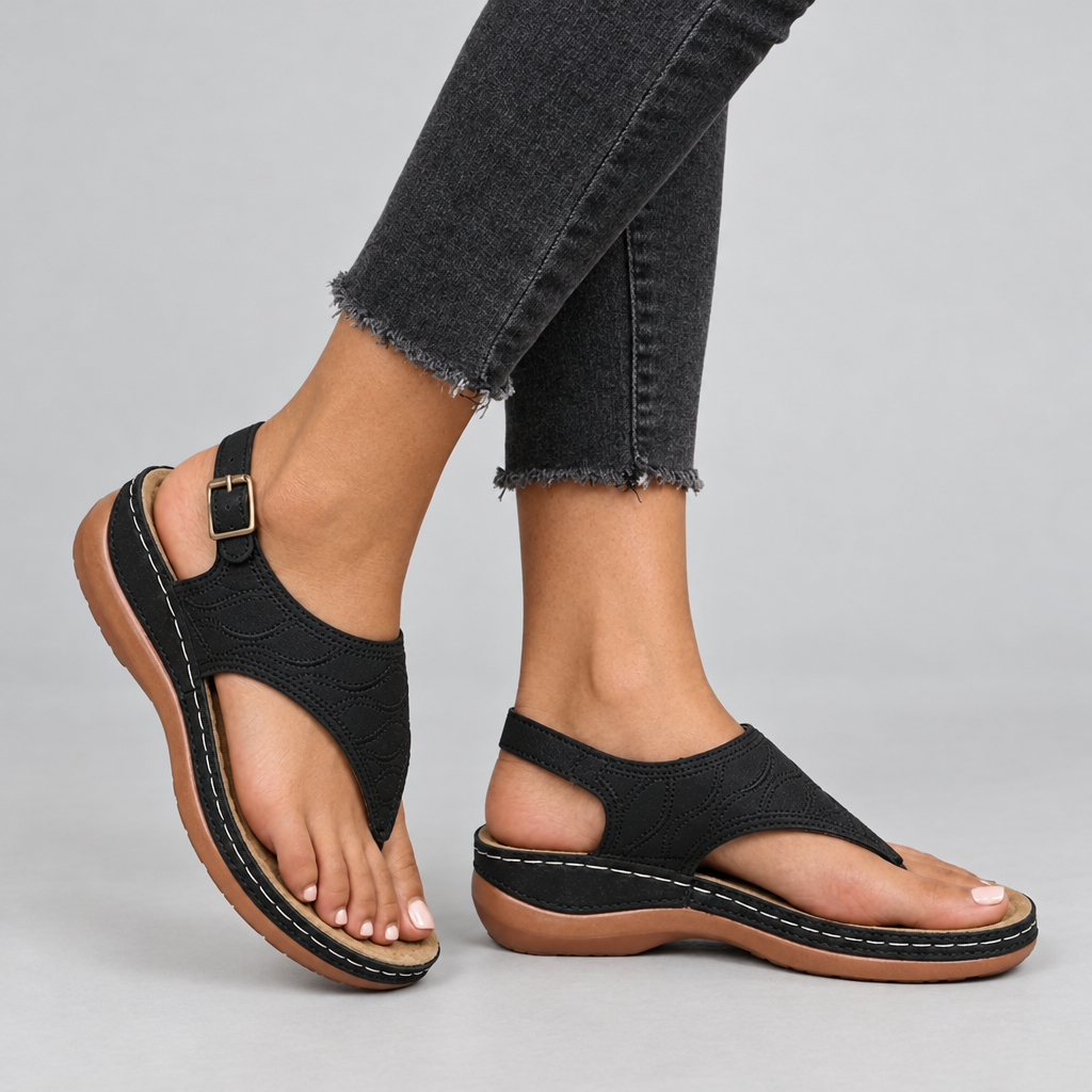 Black toe-post thong sandals on model with cushioned arch support footbed