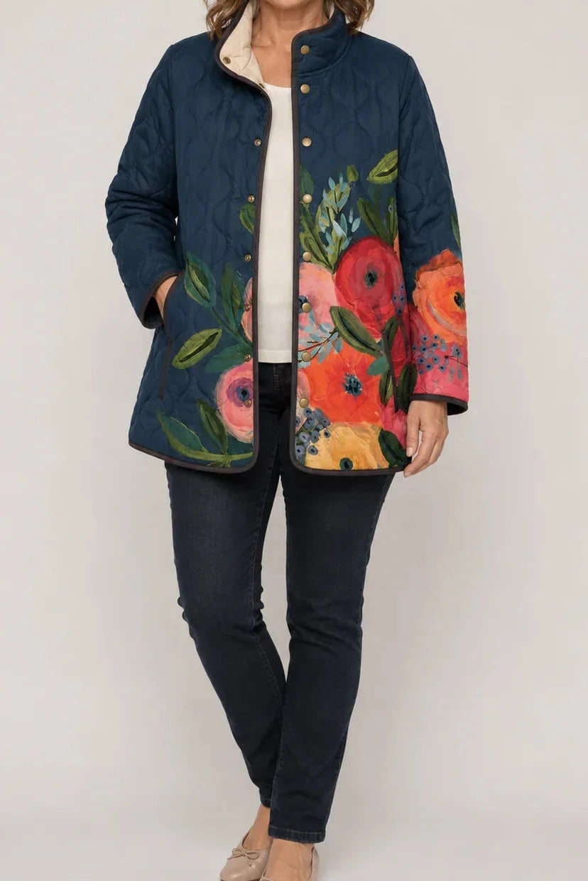 Wearbella navy quilted jacket with large colorful floral print, snap front, and side pockets.