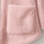Close-up of a large patch pocket on the pink fleece jacket