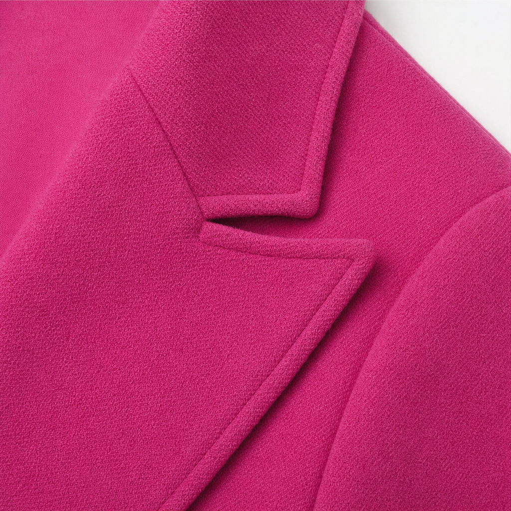 Wearbella coat detail showing a notched lapel and fuchsia wool-look fabric