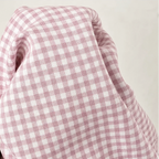Pink and white gingham fabric close-up with soft drape