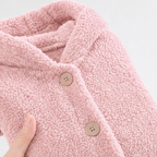 Close-up of the pink fleece jacket's hood edge and front buttons