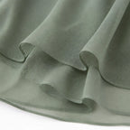Sage green chiffon skirt hem with soft layered drape