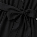 Black shirt jumpsuit waist tie detail with gathered fabric and button placket