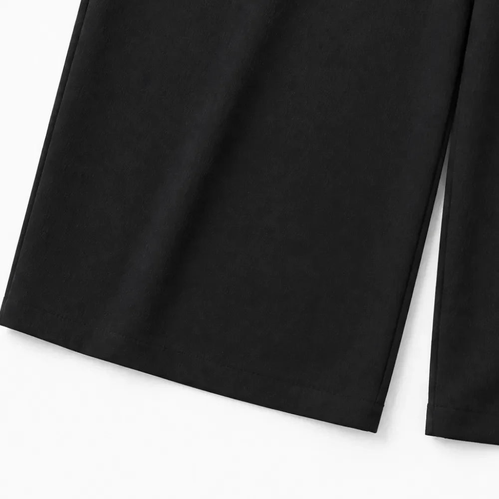 Black wide-leg shirt jumpsuit leg with straight drape and clean hem