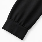 Black wide-leg shirt jumpsuit sleeve cuff and straight hem detail