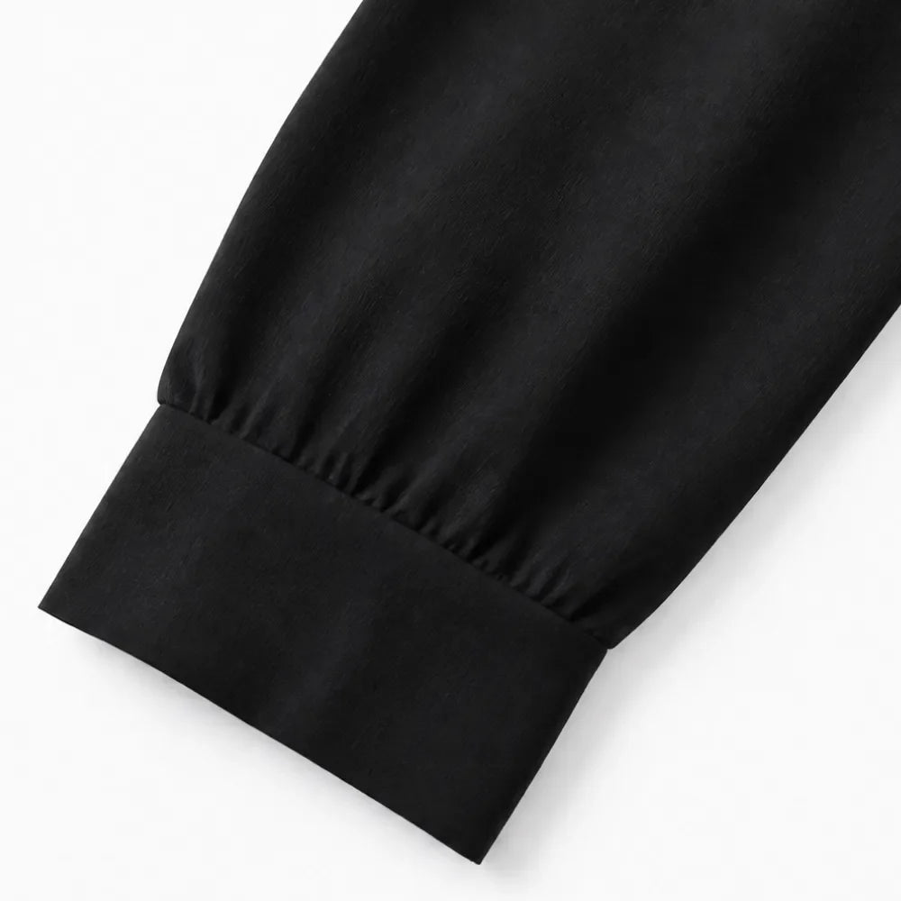 Black wide-leg shirt jumpsuit sleeve cuff and straight hem detail
