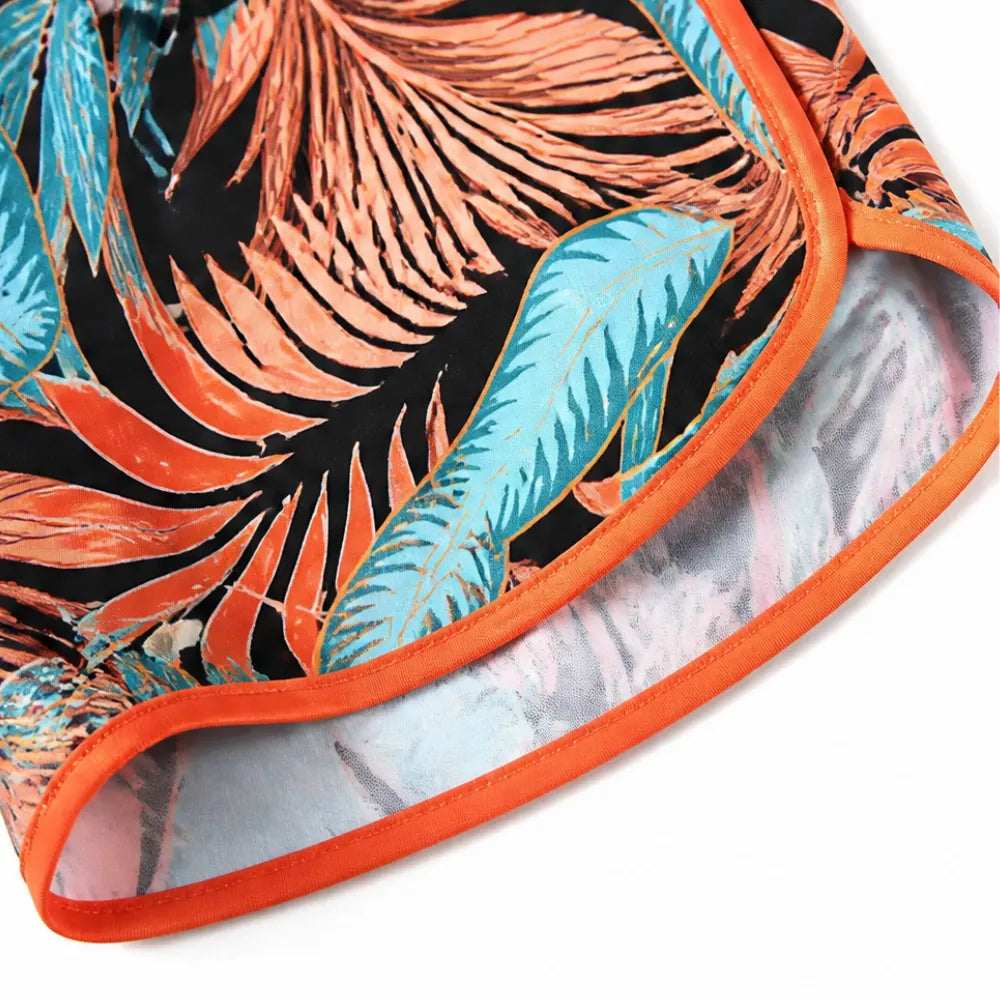 Tropical leaf swim shorts with orange-trimmed hem