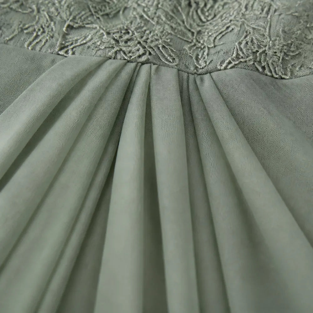 Sage green pleated chiffon-look skirt section under embroidered lace bodice