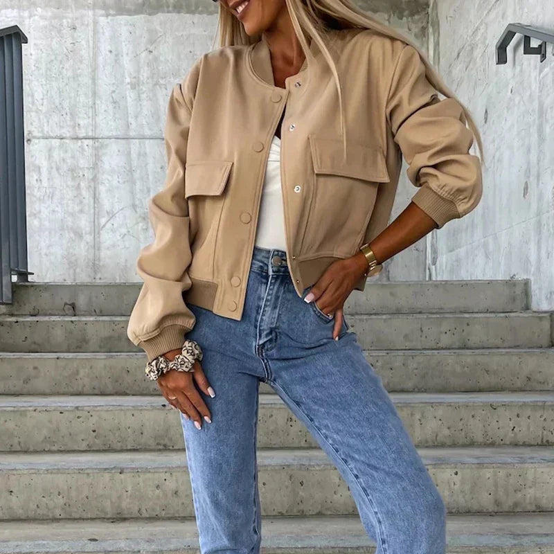 Women’s bomber jacket in tan, button front with chest flap pockets and ribbed cuffs.