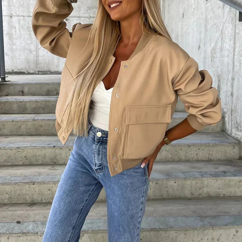 Women’s bomber jacket in beige, button front, chest flap pockets, ribbed collar and cuffs.