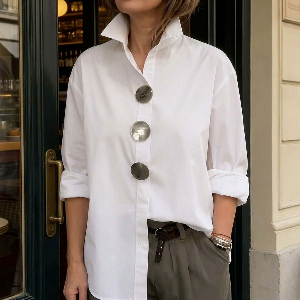 White women's blouse with oversized silver statement buttons and pointed collar