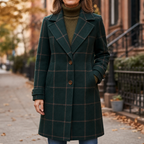 Front view of green plaid coat with two buttons, pockets, and notched lapels