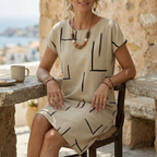Beige short-sleeve shift dress with black abstract line print and round neckline