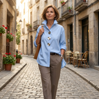 Light blue women's blouse with oversized silver statement buttons and pointed collar