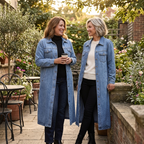 Blue longline denim coat with an oversized fit, button front, and chest pockets, shown on two wearers