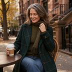 Green plaid coat detail with notched lapels, buttons, and cuff tab