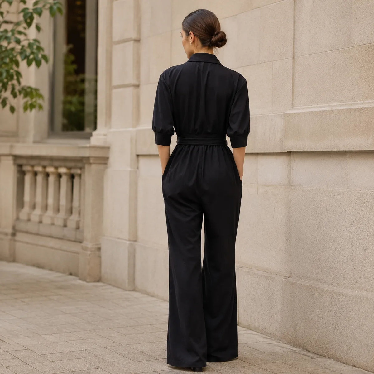 Black belted wide-leg shirt jumpsuit with back gathers and tie waist detail