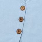 Light blue linen-look top with round wooden button placket close-up