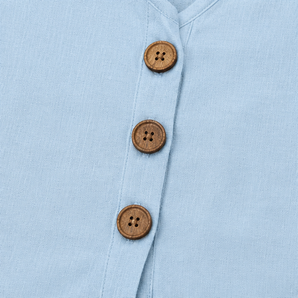 Light blue linen-look top with round wooden button placket close-up