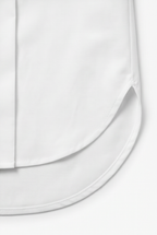 White blouse curved hem with neat stitching