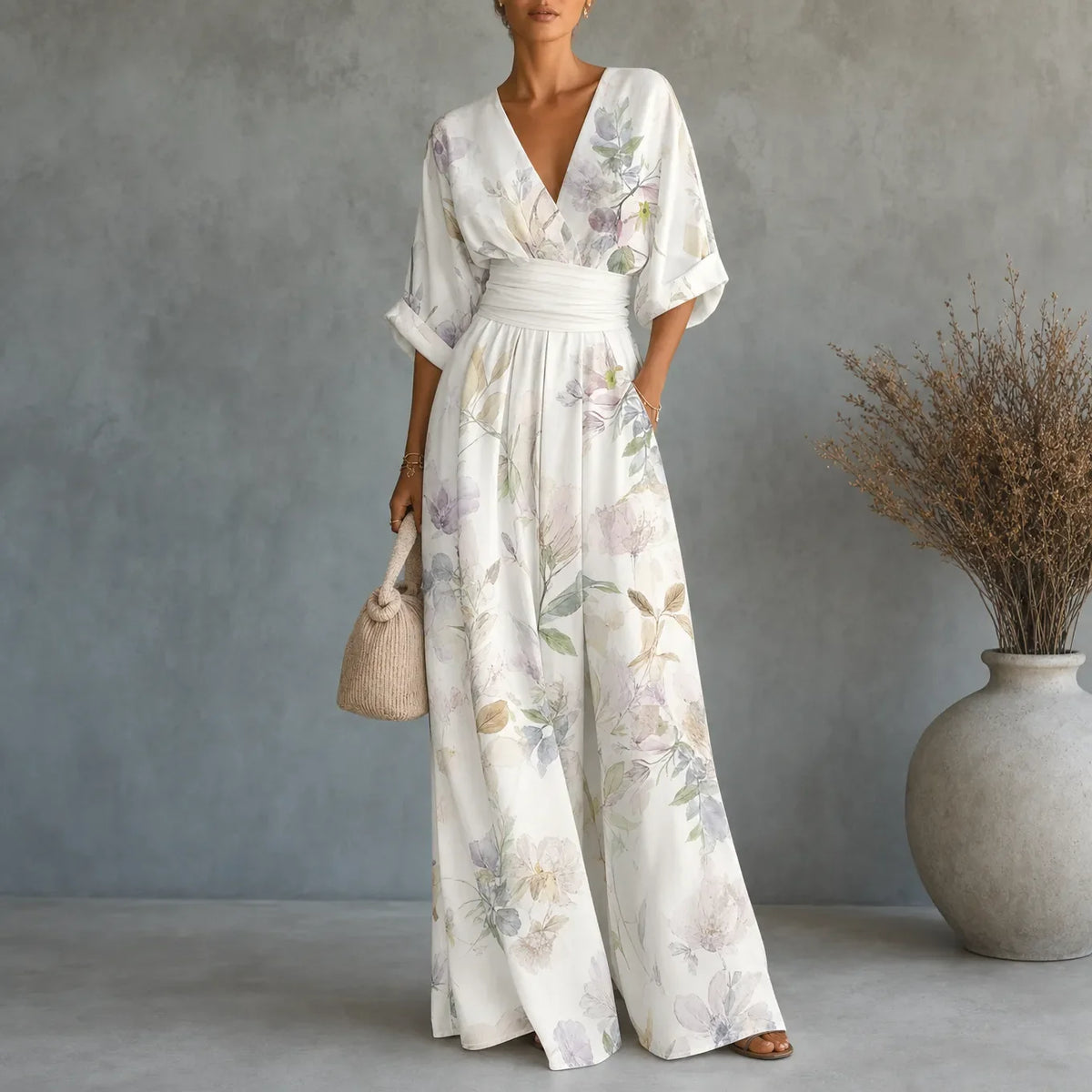 Women's floral V-neck wide-leg jumpsuit with cinched waist and pockets, cream.