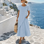 Women's asymmetrical button midi dress, powder blue, short sleeves and flowing overlay.