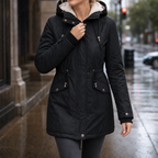 Black fleece-lined padded parka with hood, drawstring waist, and buttoned flap pockets