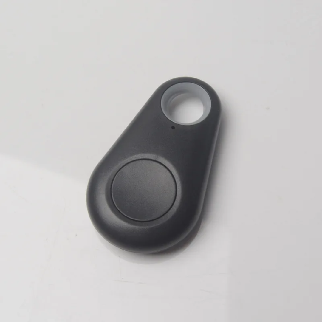 Black mini GPS tracker key finder close-up with circular button and attachment loop.