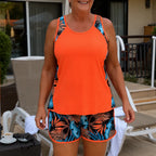 Women’s coral tankini top with tropical leaf swim shorts set, orange-trim detail
