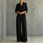 Black belted shirt jumpsuit with button front and wide-leg trousers