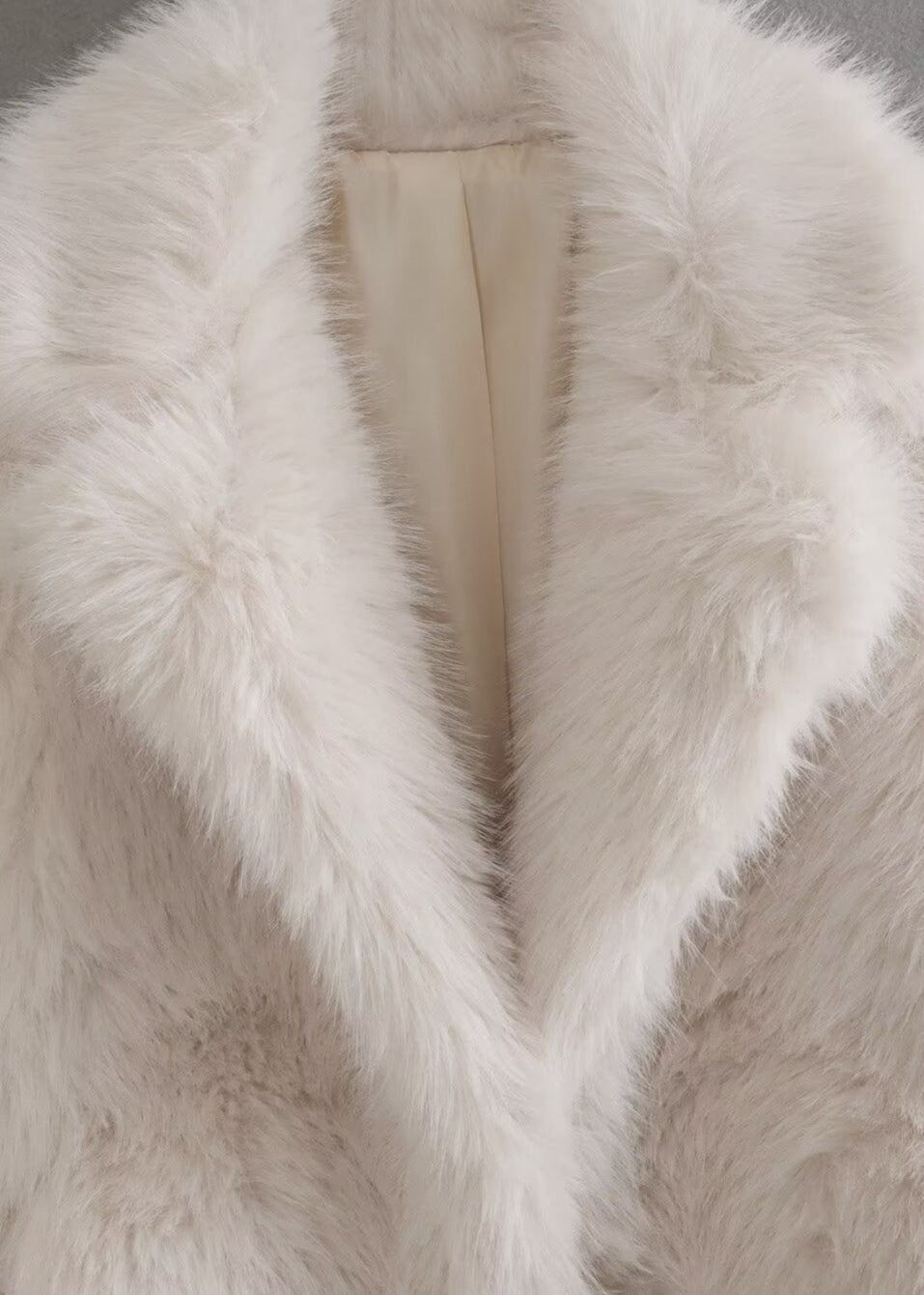 White plush teddy coat detail with stand-up collar and open front lining